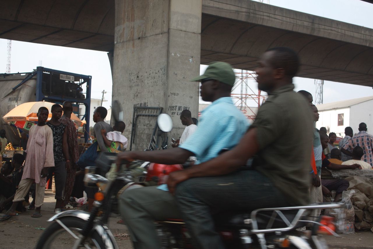 PEOPLE RIDING BICYCLE ON STREET