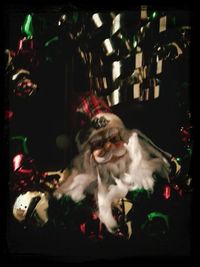 Dog standing on illuminated christmas tree