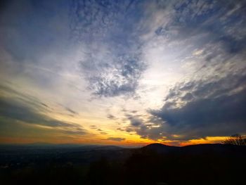 Scenic view of silhouette mountains against sky during sunset