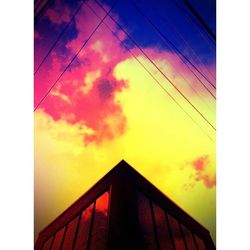 Low angle view of building against sky at sunset