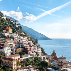 Townscape by sea against sky