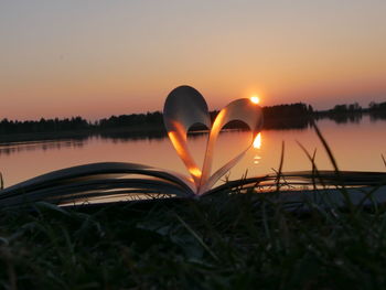 Close-up of heart shape against sunset sky