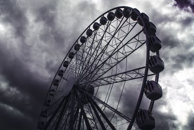 Low angle view of ferris wheel against sky