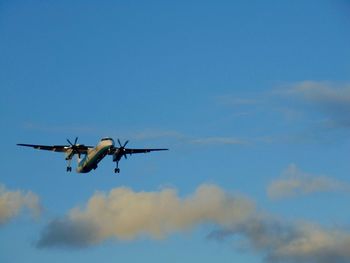 Low angle view of airplane flying against sky