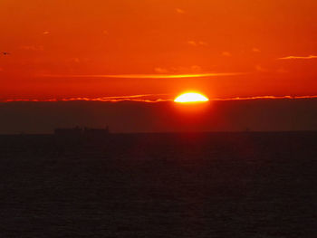 Scenic view of sea against romantic sky at sunset