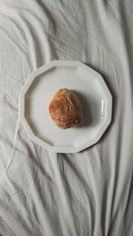 High angle view of food in plate on bed