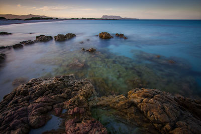 Scenic view of sea against sky at sunset