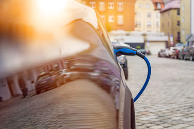 Close-up of car refueling on city street