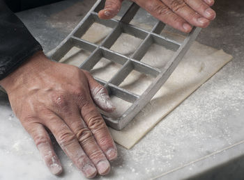 Cropped hands preparing food