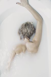 High angle view of woman relaxing in bathtub