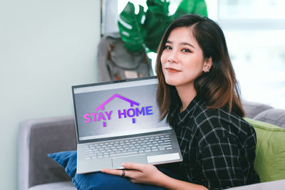 Young woman using phone at home