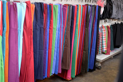 Multi colored clothes hanging in store