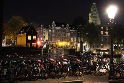 Bicycles against illuminated city at night