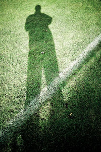 Shadow of man on field