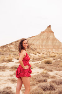 Portrait of woman standing on land against clear sky