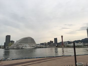 View of city buildings against cloudy sky