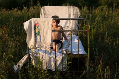 Portrait of man sitting in basket