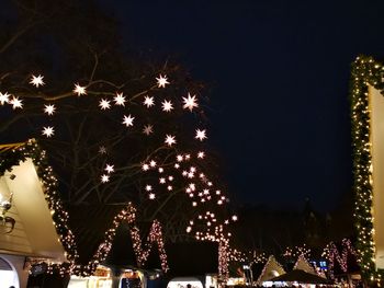 Low angle view of illuminated christmas tree at night