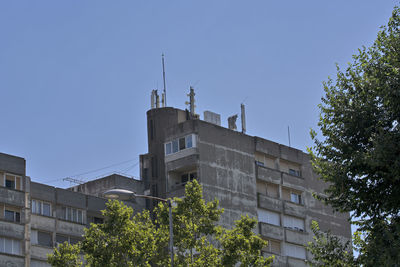 Low angle view of building against clear blue sky