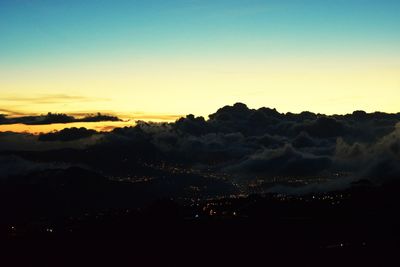 Silhouette landscape against sky at sunset