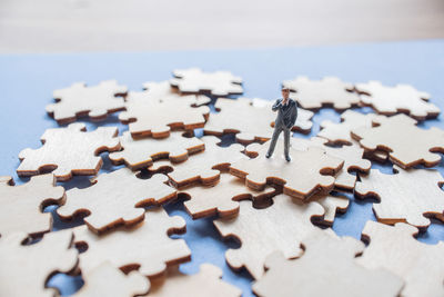 Figurine on wooden jigsaw puzzle