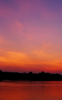 Scenic view of lake against romantic sky at sunset