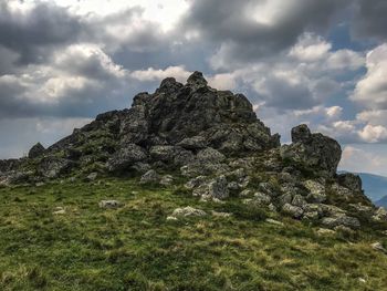 Rock formation on land against sky