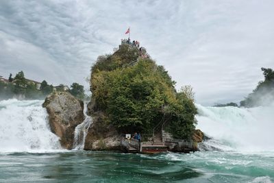 Scenic view of waterfall against sky