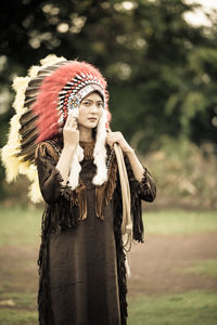 Full length of woman wearing hat standing on field