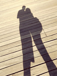 Shadow of person on boardwalk