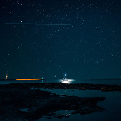 Scenic view of sea against sky at night