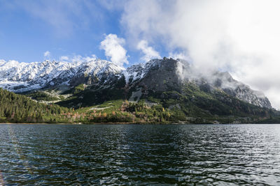 Scenic view of snowcapped mountain against cloudy sky