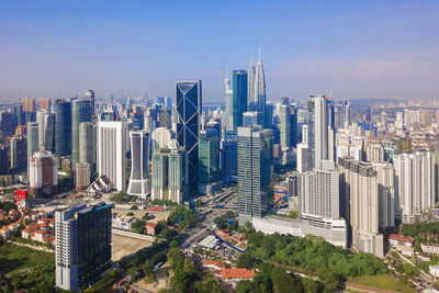 Aerial view of modern buildings in city against sky