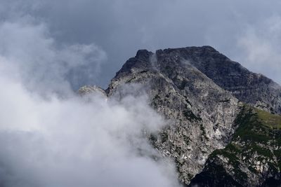 Low angle view of smoke on mountain against sky