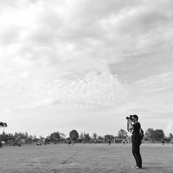 Full length of man standing on field against sky