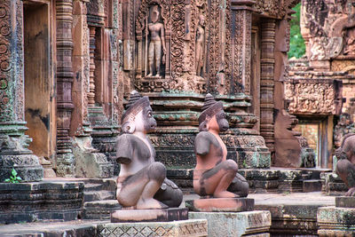 Banteay srei or banteay srey temple site among the ancient ruins of angkor wat hindu temple complex