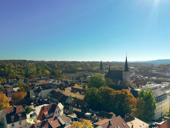 High angle view of townscape against clear blue sky