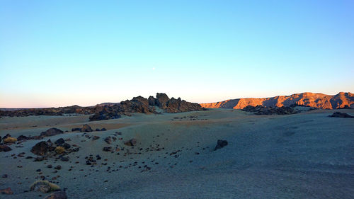 Scenic view of landscape against clear sky during sunset