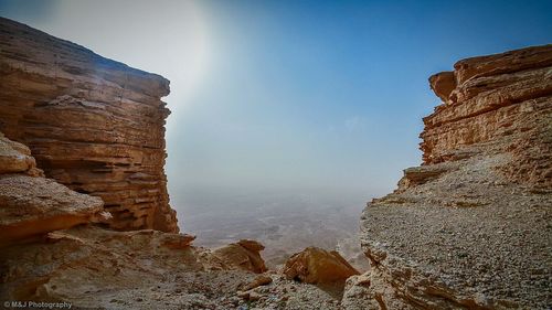 Scenic view of rock formation against blue sky