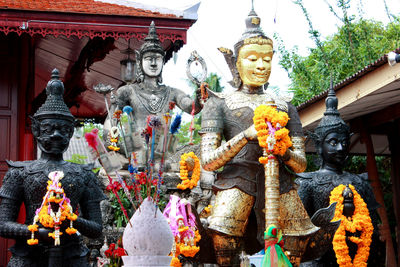 Statue outside temple against building