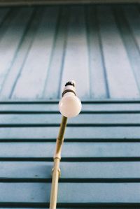 Low angle view of light bulb on wall