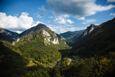 Scenic view of mountains against cloudy sky