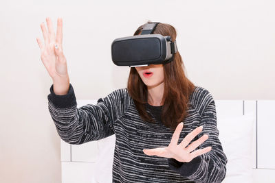 Young woman virtual reality while sitting at home
