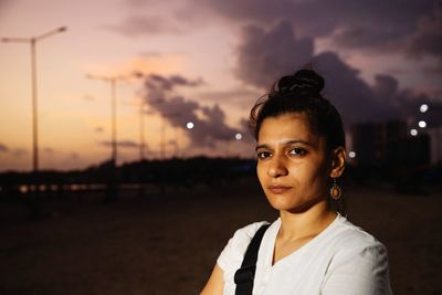 Portrait of woman standing against sky during sunset