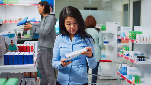 Portrait of female friends working in laboratory