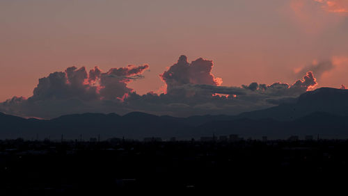 Scenic view of silhouette mountains against sky during sunset