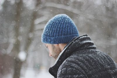 Close-up of man in warm clothing during snowfall