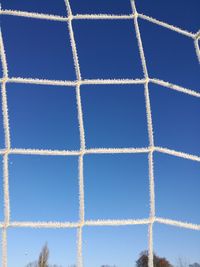 Low angle view of vapor trail against blue sky