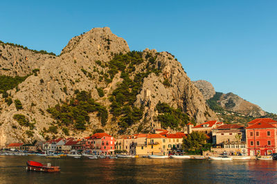 Town by sea against clear sky