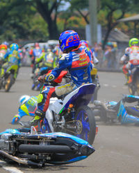 People riding motorcycle on street